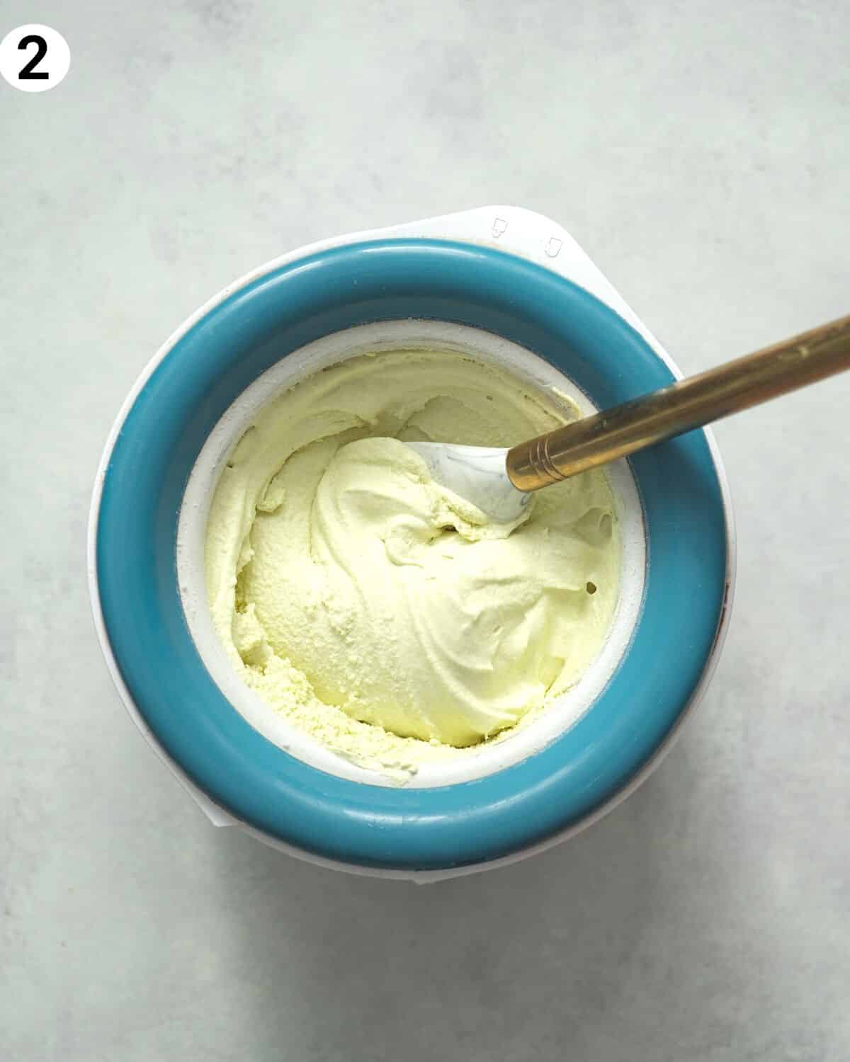 vegan pistachio ice cream in an ice cream maker.
