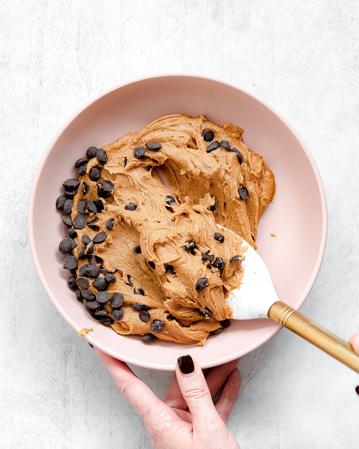 folding chocolate chips through cashew butter fudge.