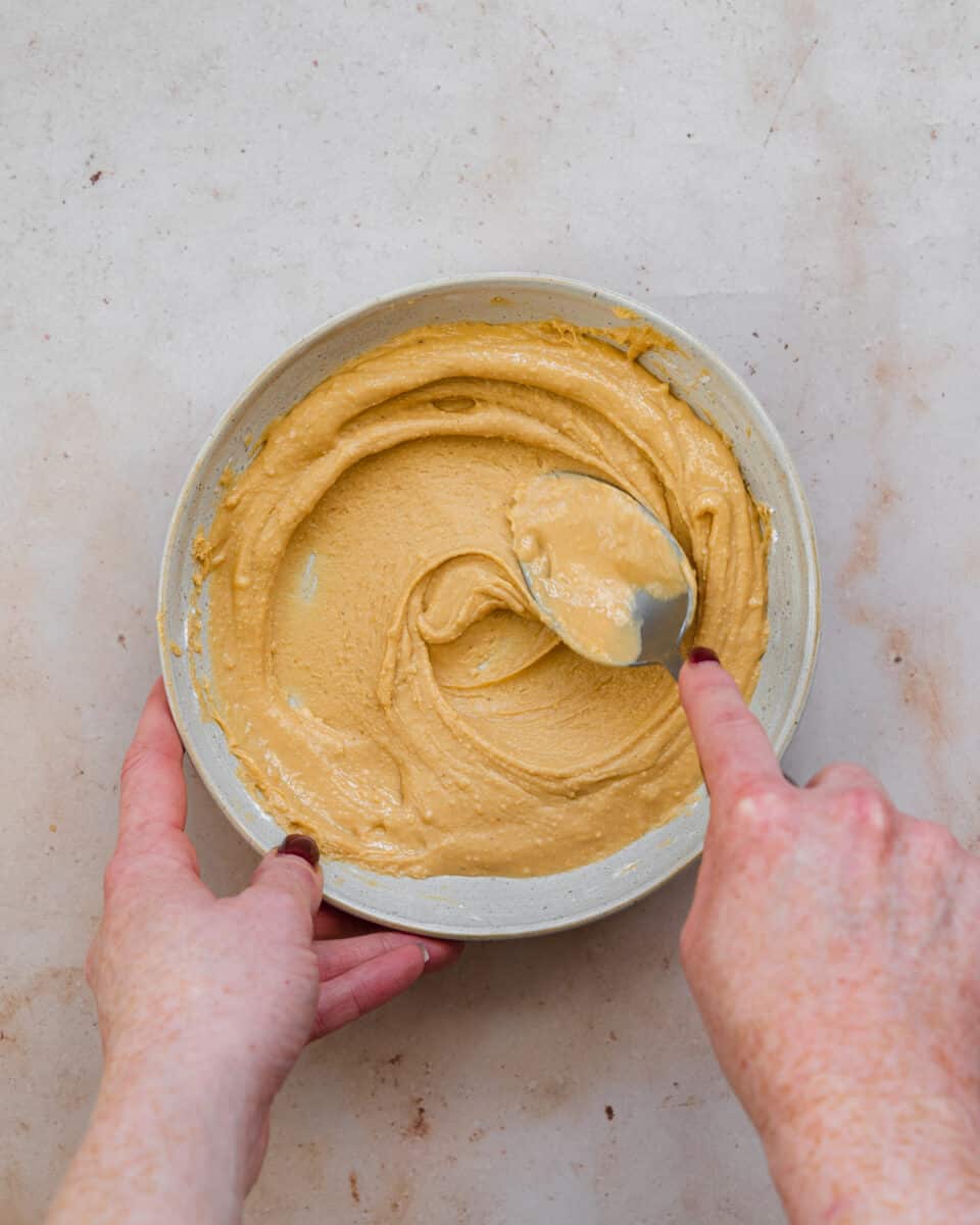 mixing peanut butter in a bowl.