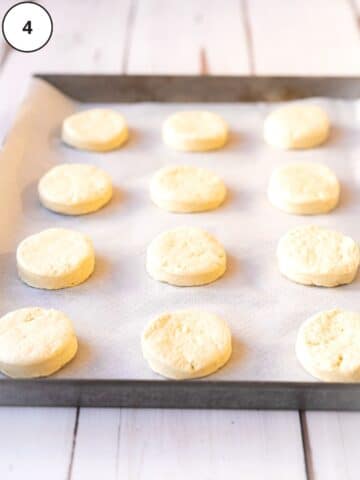 cut out donut rounds on a baking tray lined with parchment paper, being left for 20 minutes to prove.
