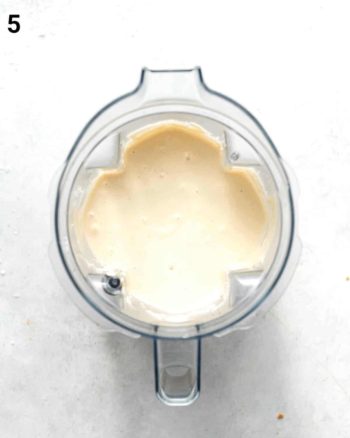top down view of cheesecake filling ingredients in a blender.