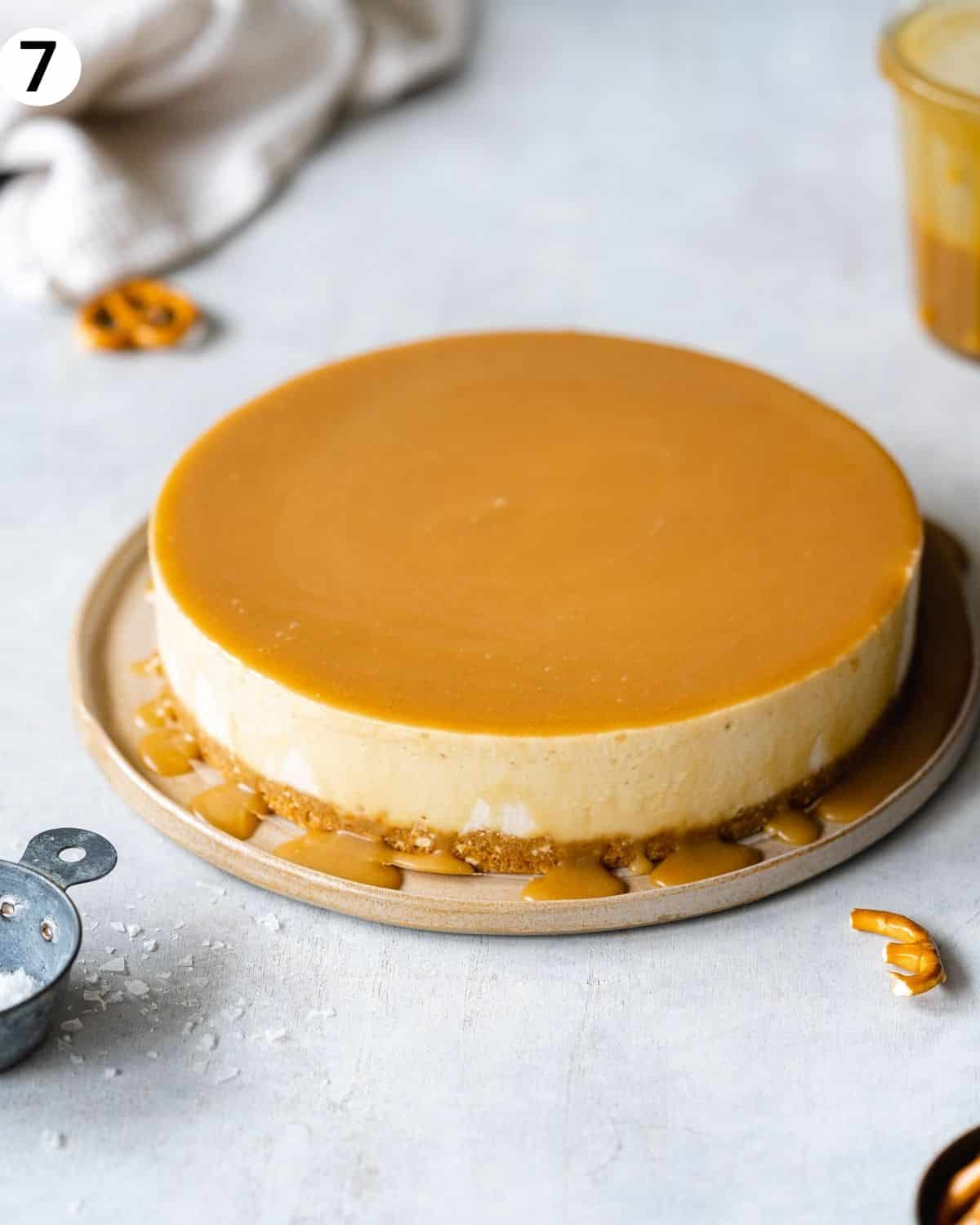 cheesecake with caramel sauce on top and dripping around the edges.