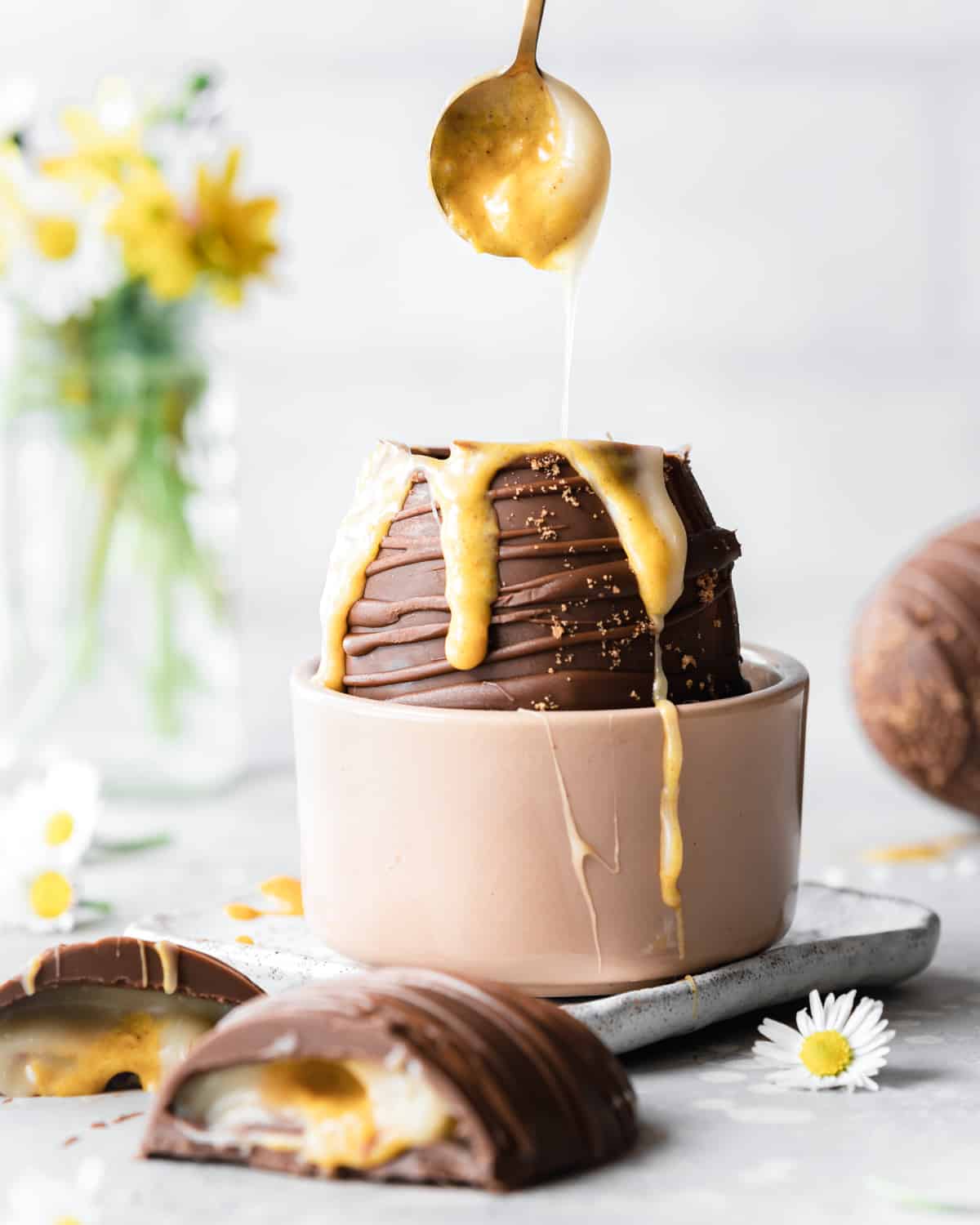 giant creme egg with spoon dipping into the yolk center.