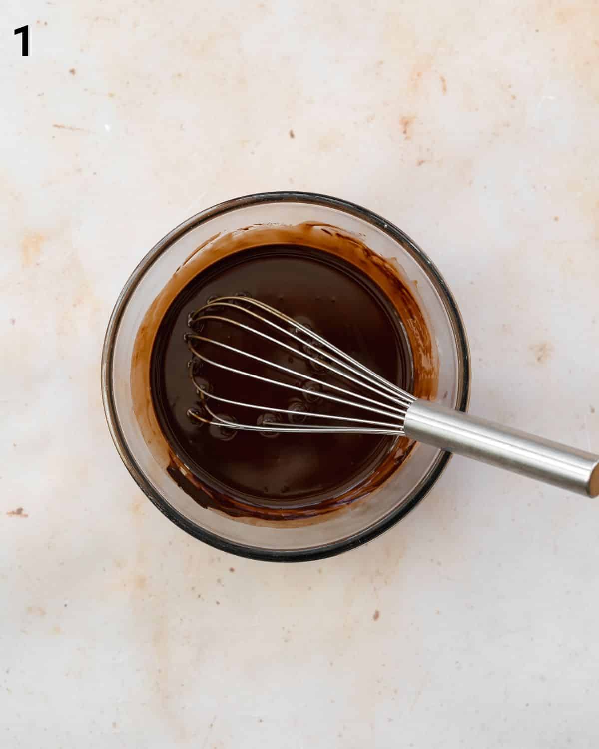 whisking chocolate in a bowl.