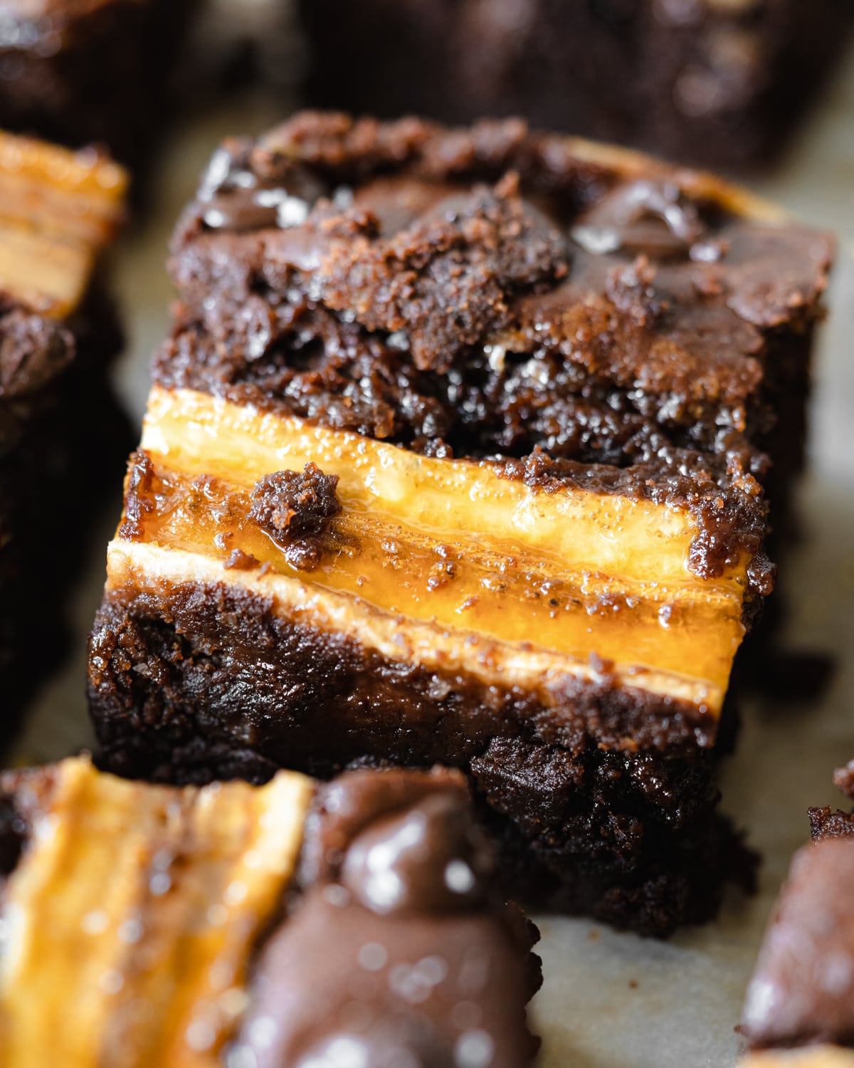 close up of banana brownies with sliced bananas on top.