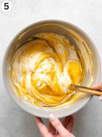 folding passionfruit pulp into whipped coconut cream.
