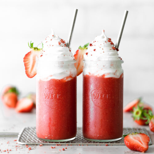 2 strawberry slushie drinks with marshmallow topping on a cooling rack.