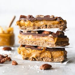 stack of pumpkin caramel slices with jar of caramel in background.