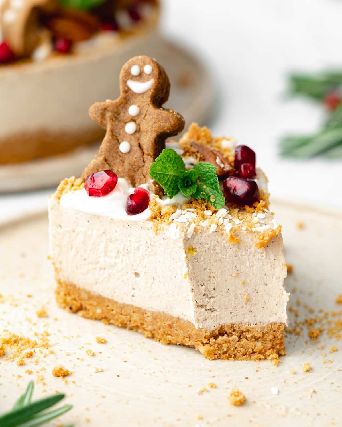 slice of gingerbread cheesecake with gingerbread man on top.