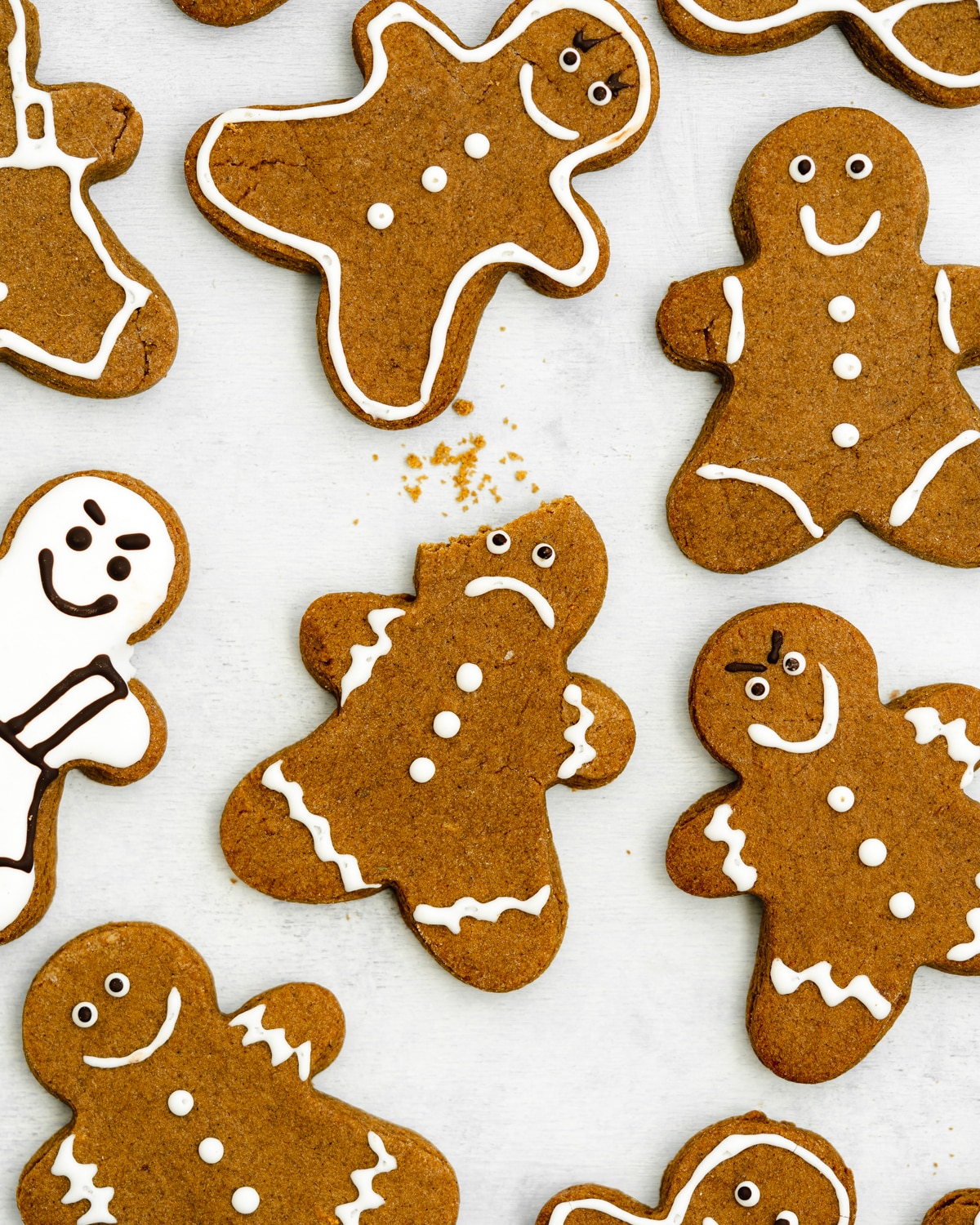 gingerbread men with different facial expressions on a grey surface.
