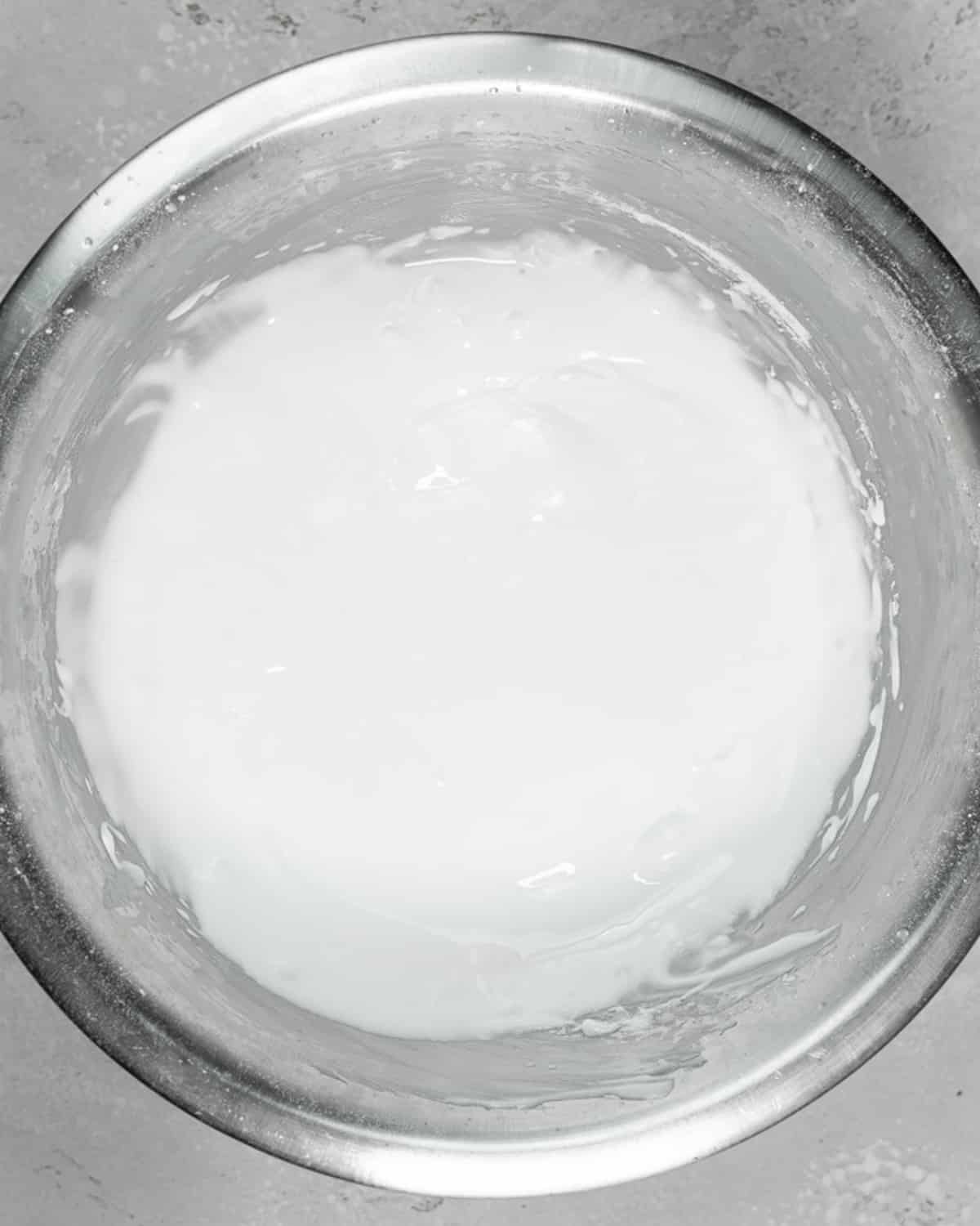 whisked royal icing in a bowl.