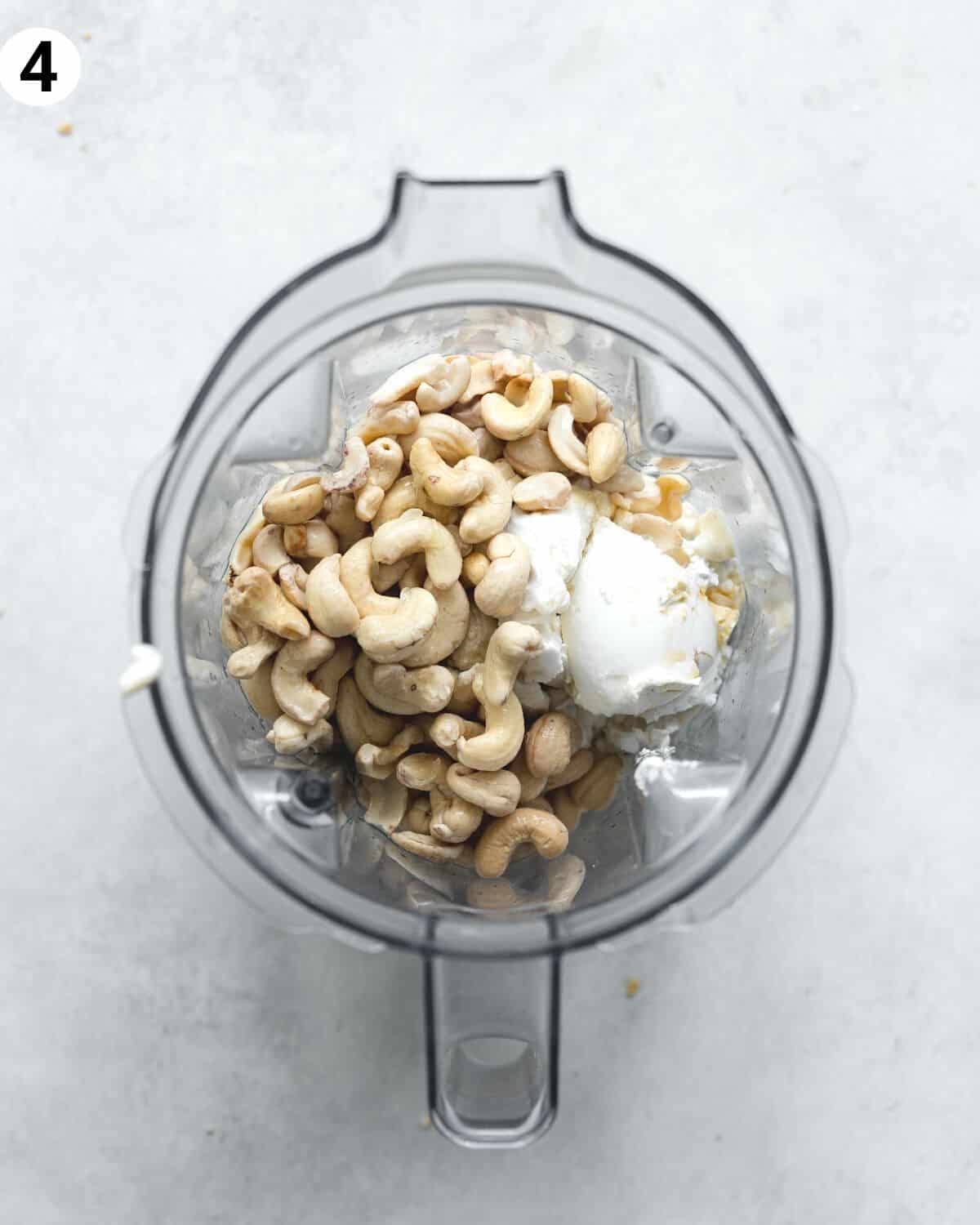 top down view of ingredients for mango cheesecake filling in a blender.