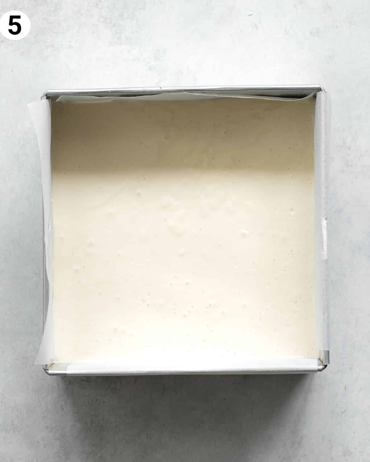 top down view of cheesecake in a square cake pan.