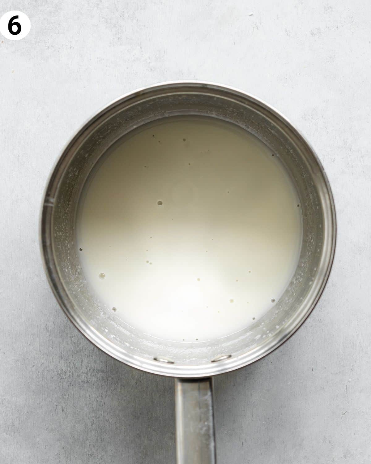 top down view of saucepan with mango curd.