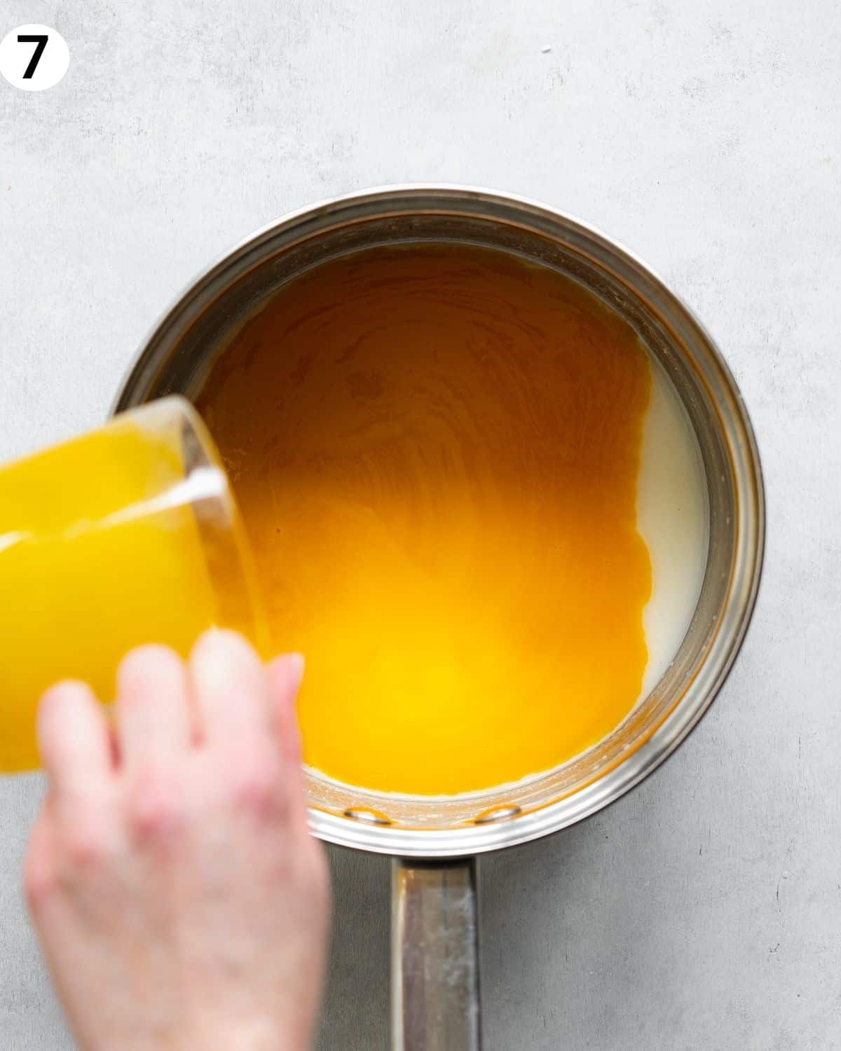 top down view of saucepan with mango curd.