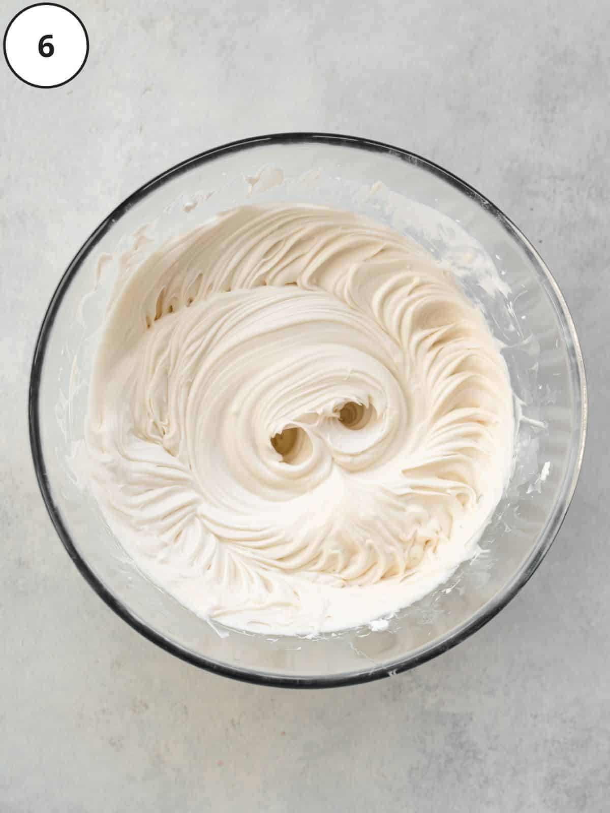 whipped coconut milk and vegan condensed milk whisked until creamy in a bowl.