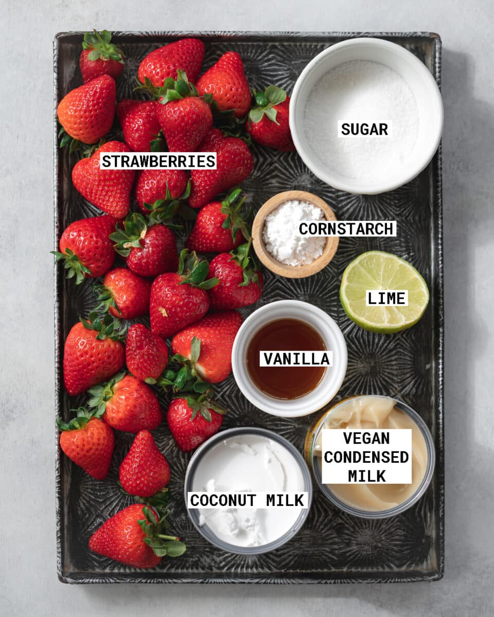 top down view of ingredients for strawberry ice cream measured out on a tray.