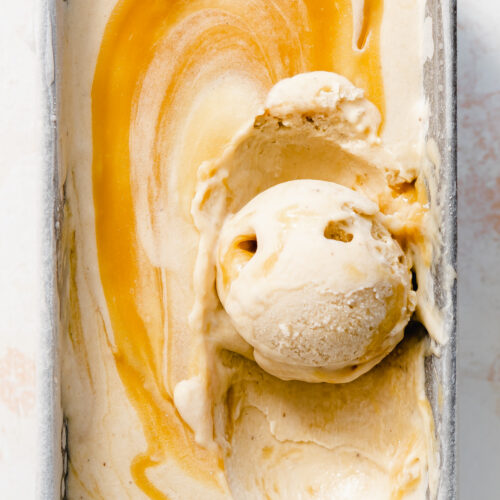 close up of banana ice cream swirled with caramel sauce.