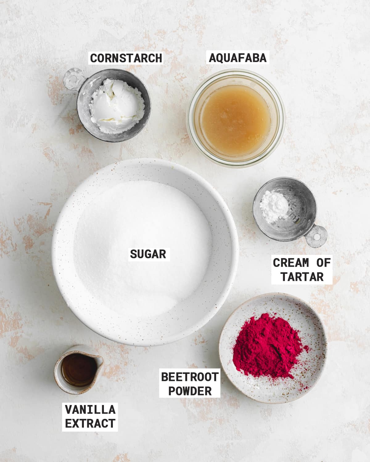 ingredients for making pink meringue kisses.