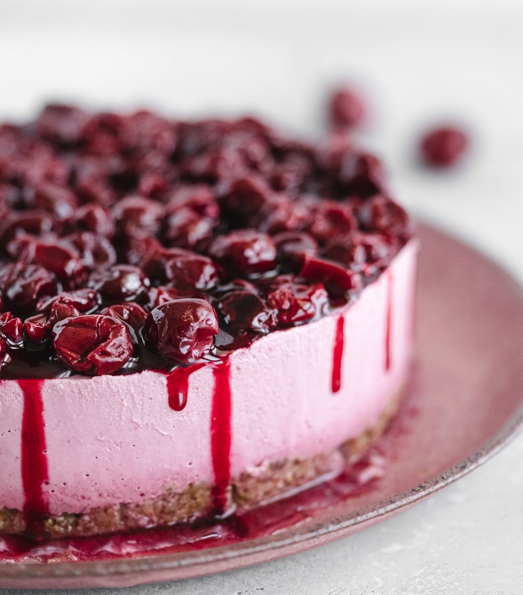 closeup of cherry cake on pink plate.