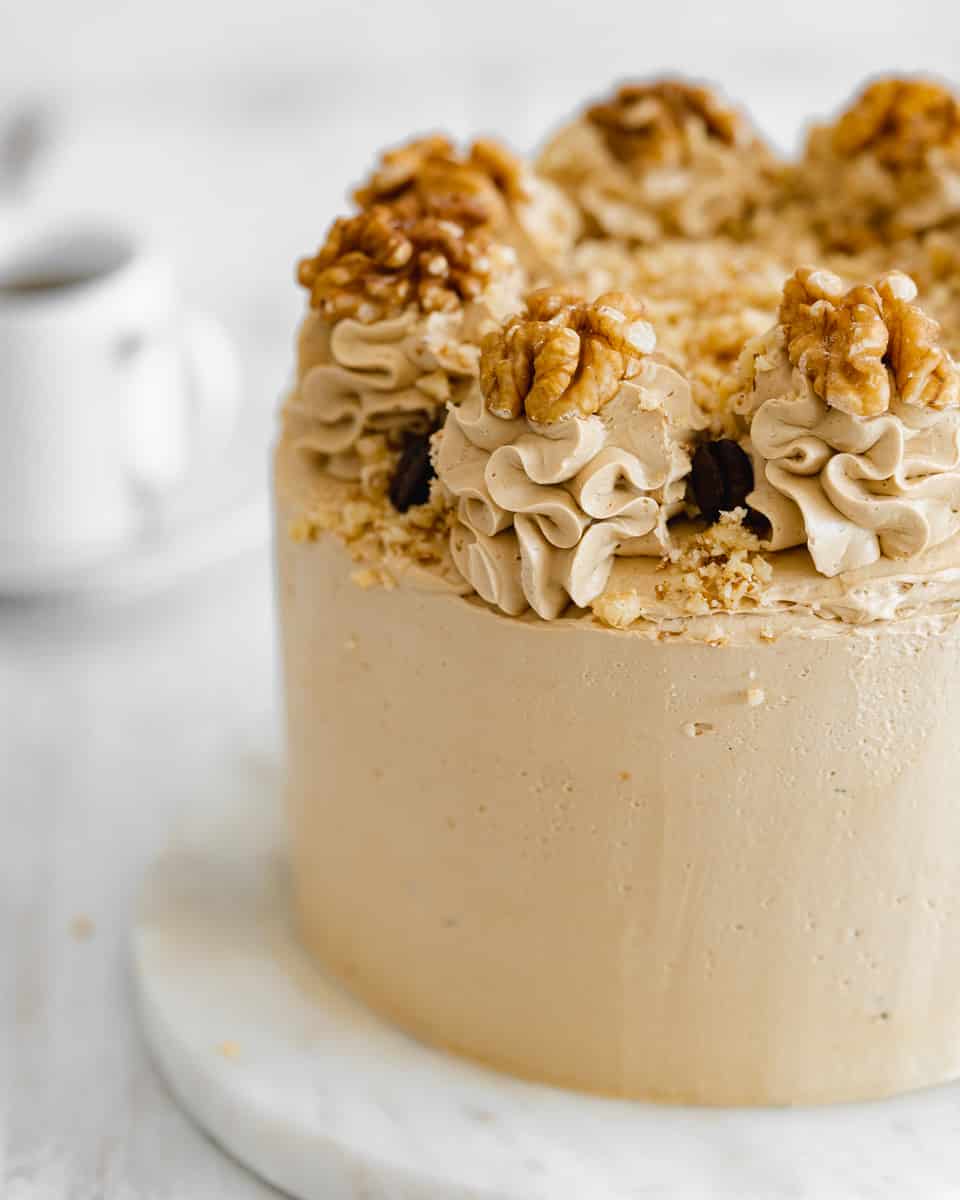 vegan coffee frosting piped onto a coffee cake.
