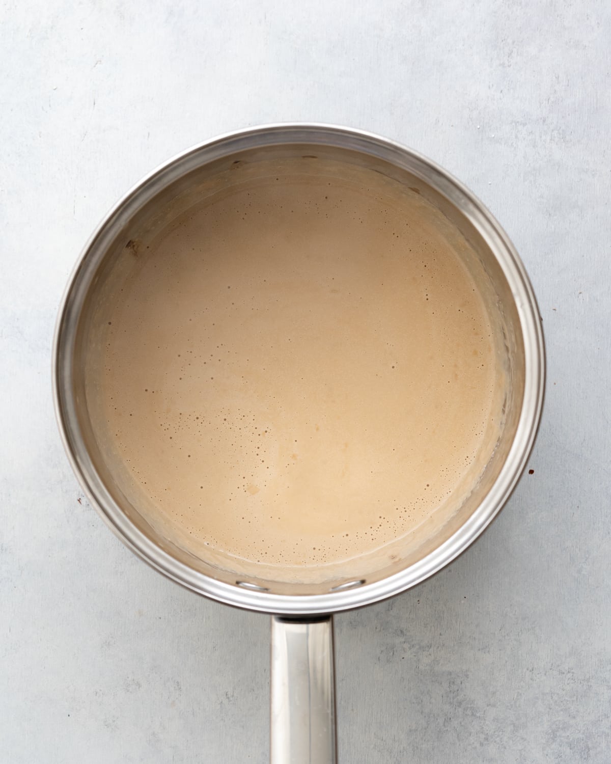 coffee and coconut milk heated in a saucepan.