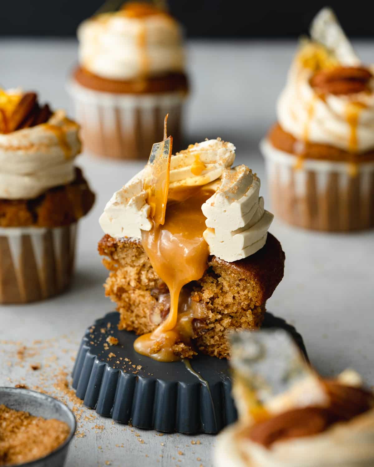 cupcake filled with caramel sauce with buttercream on top.