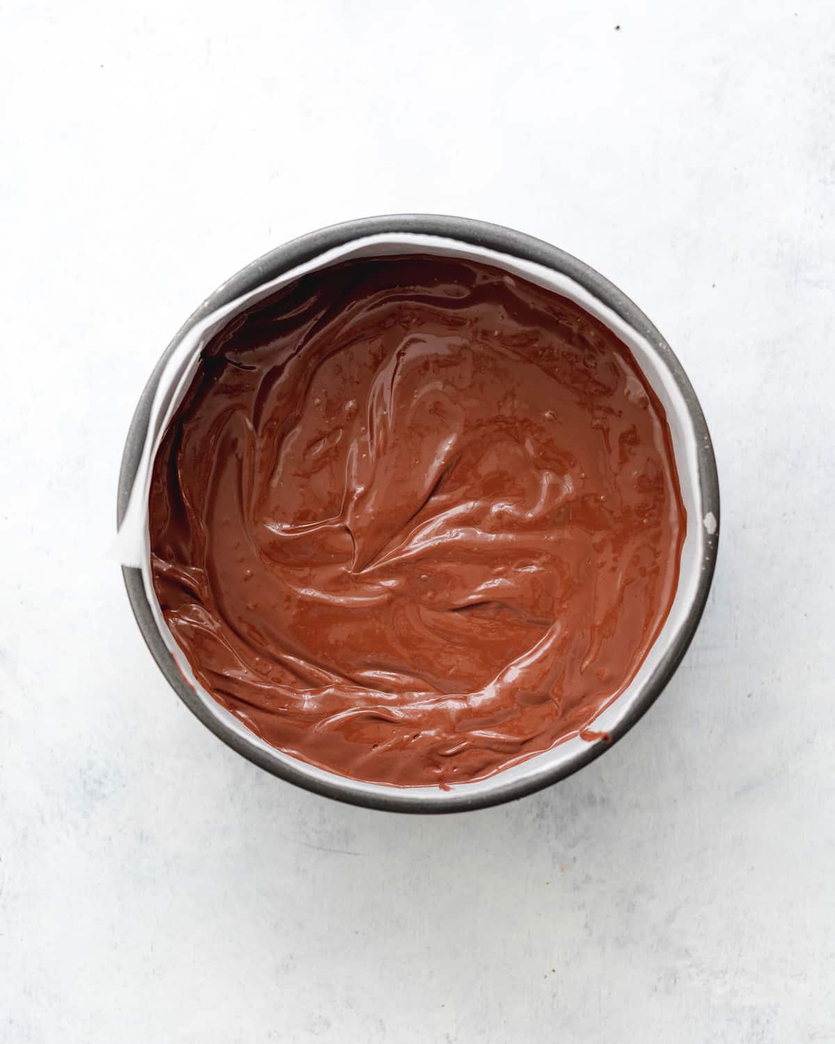 chocolate cheesecake in a cake tin.