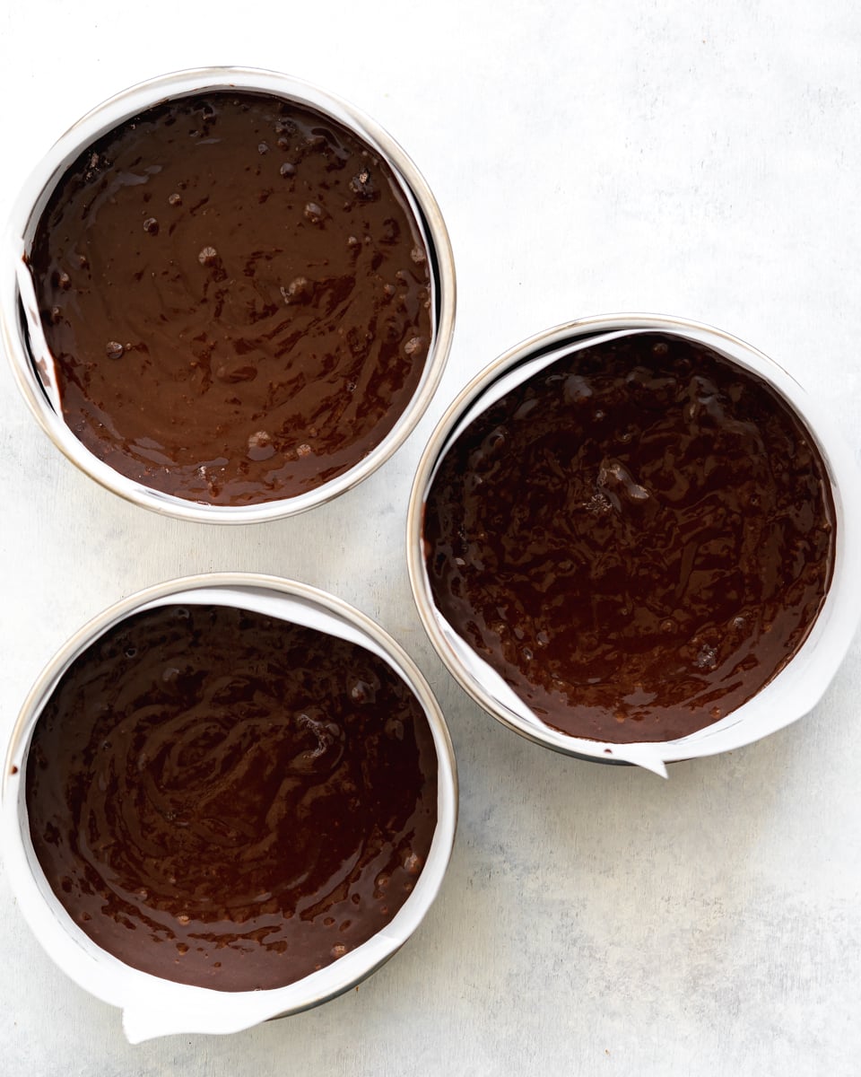 vegan chocolate cake batter in cake tins.