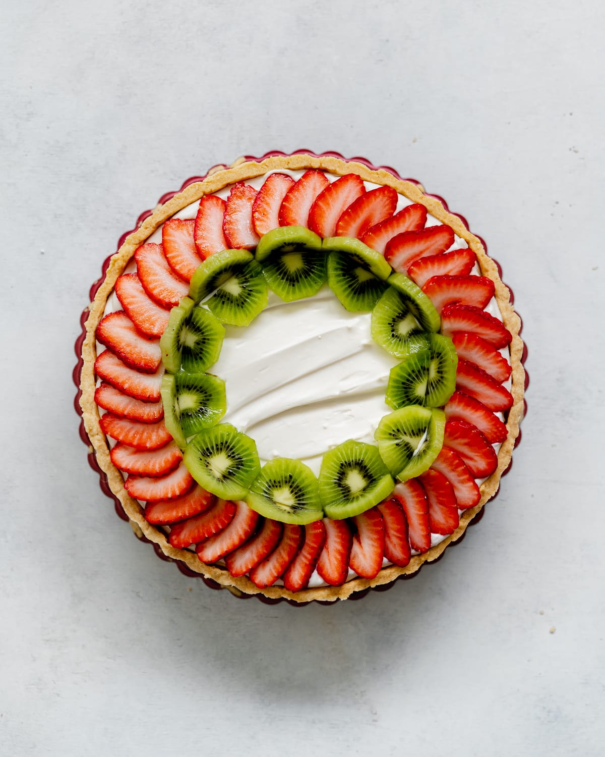 assembling a fresh fruit tart.