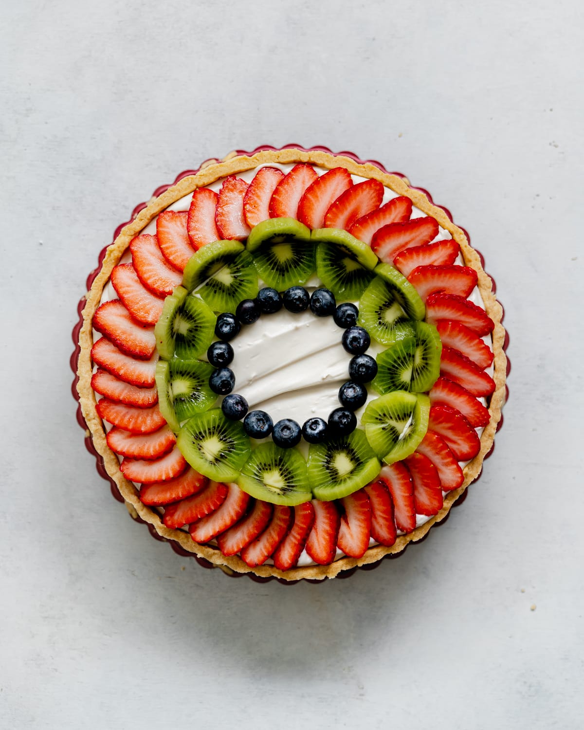 assembling a fresh fruit tart.