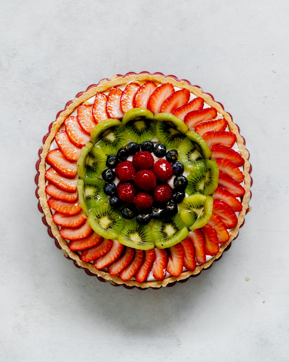 assembling a fresh fruit tart.