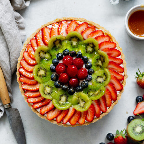 dairy-free custard tart with fresh fruit and berries on top.