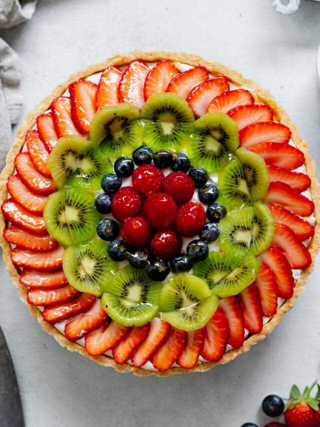 dairy-free custard tart with fresh fruit and berries on top.