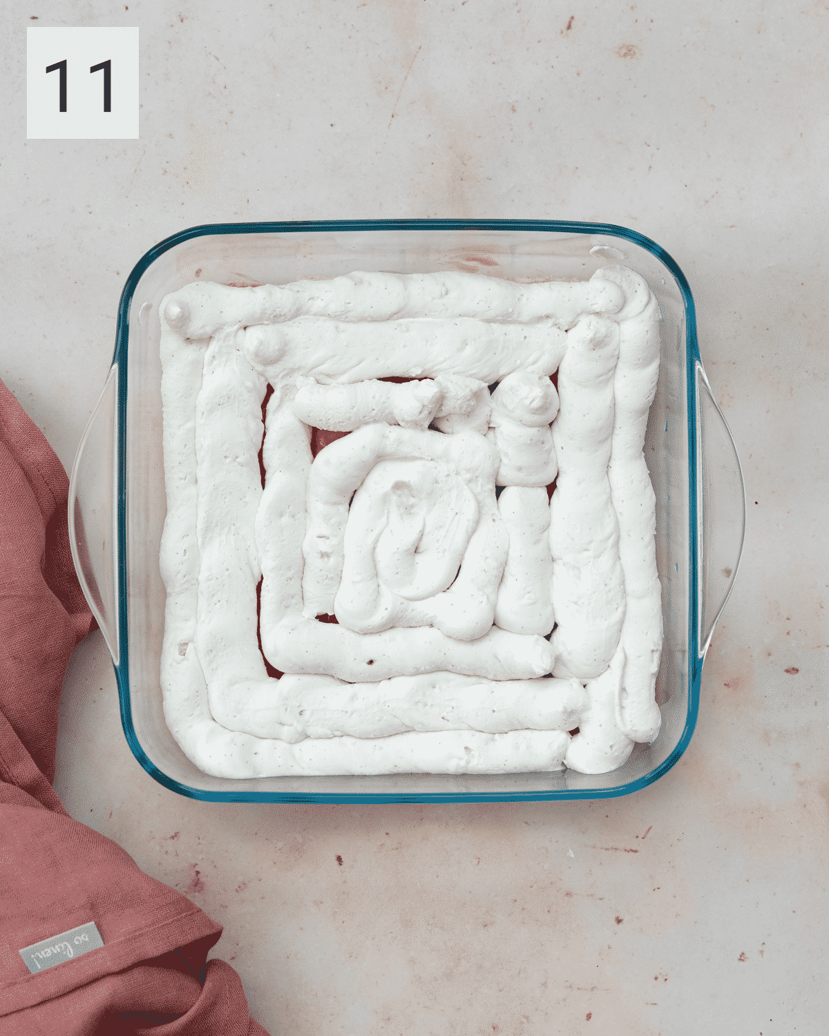 layering a strawberry tiramisu.