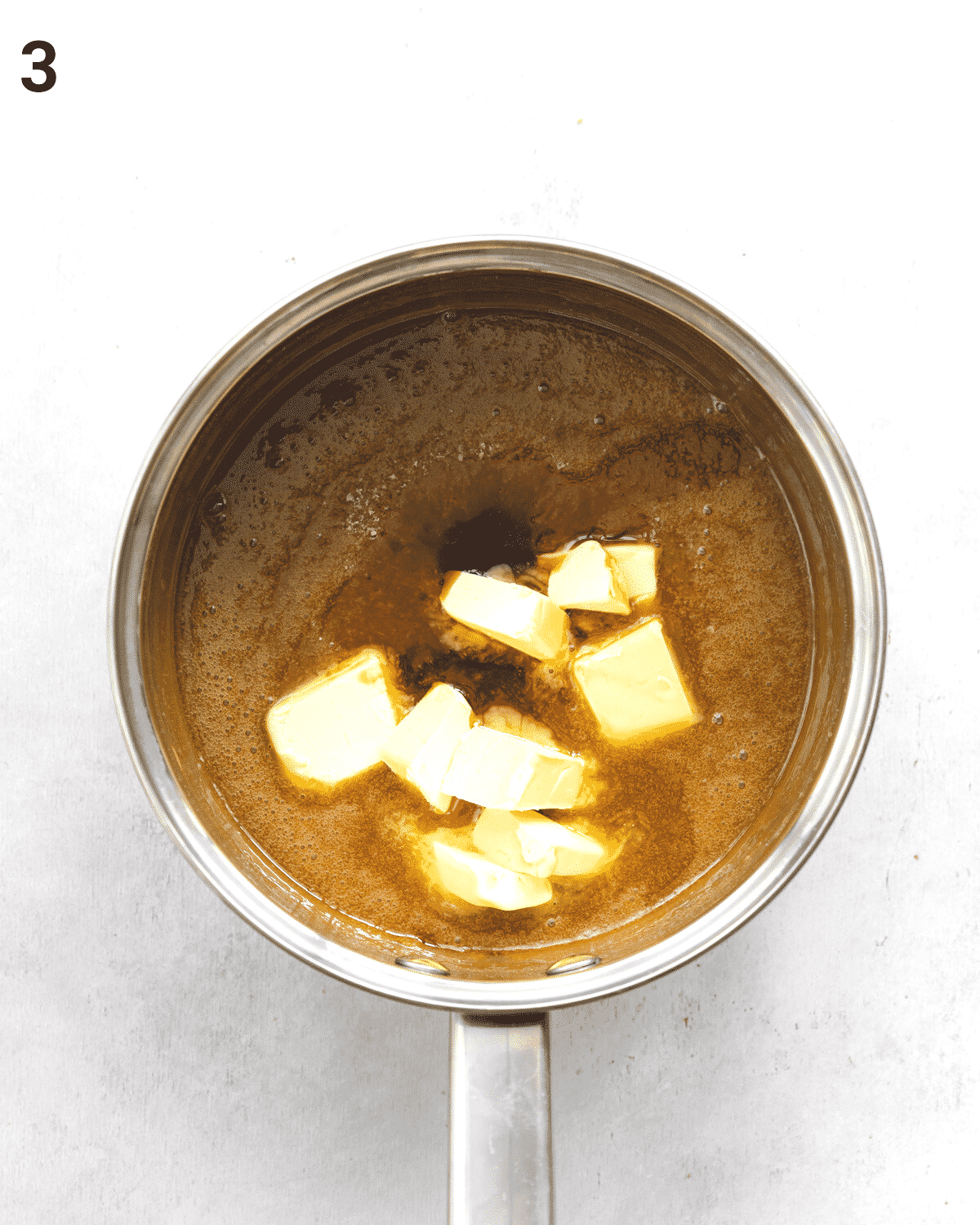 top down view of caramel sauce with vegan butter in a saucepan.