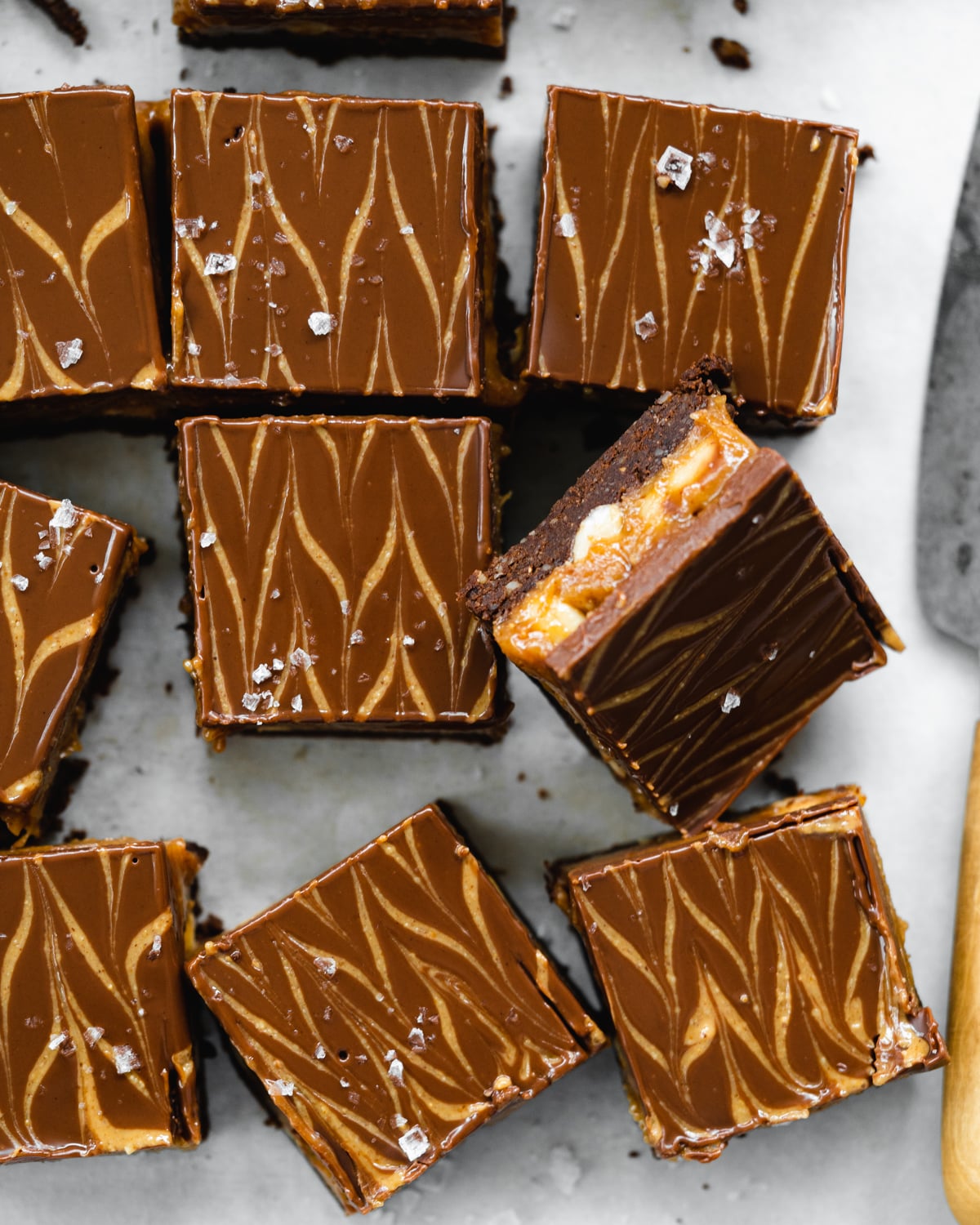 top down view of peanut butter swirled chocolate brownies with a layer of peanut butter in the center.