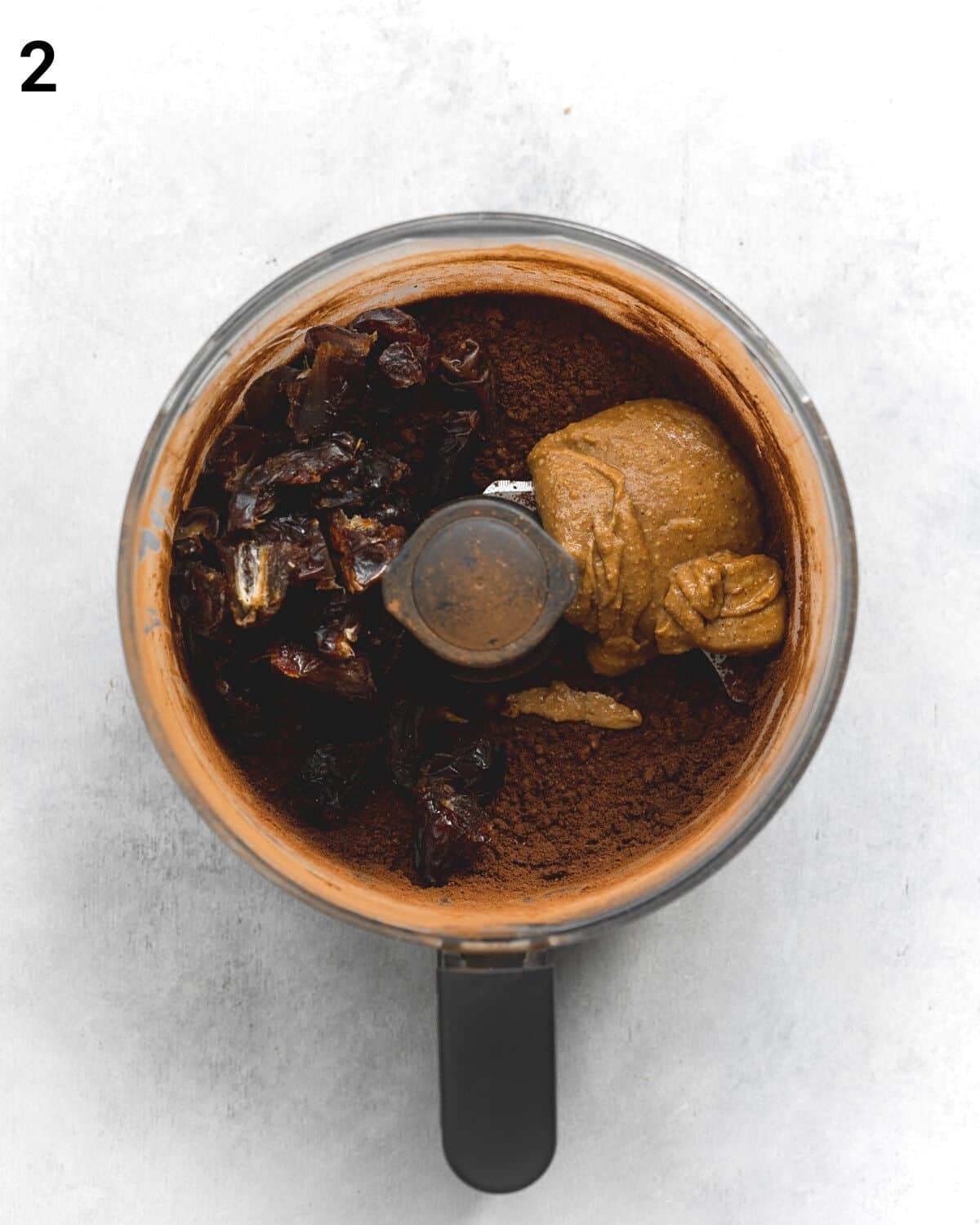 top down view of food processor filled with brownie ingredients.