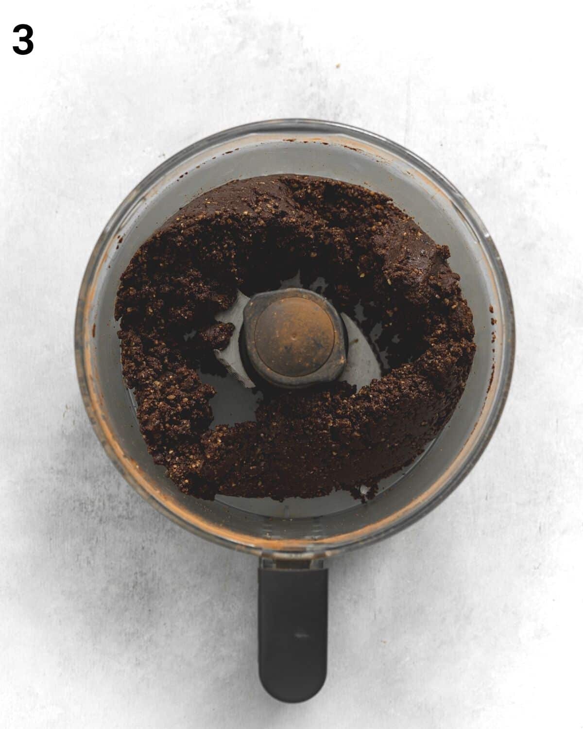 top down view of blended brownie ingredients in a food processor.