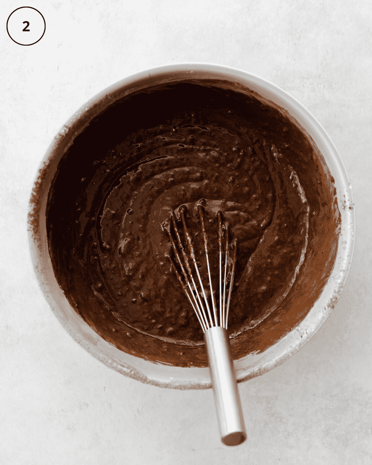 top down view of chocolate cake batter in a bowl.