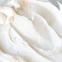 whipped coconut cream in a clear bowl.