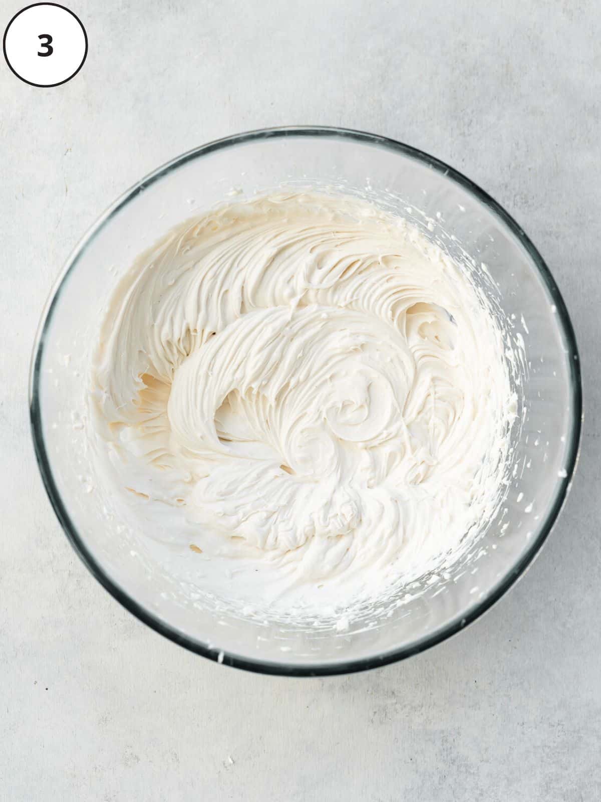 whipped custard and cream in a bowl to make dairy-free vanilla ice cream.