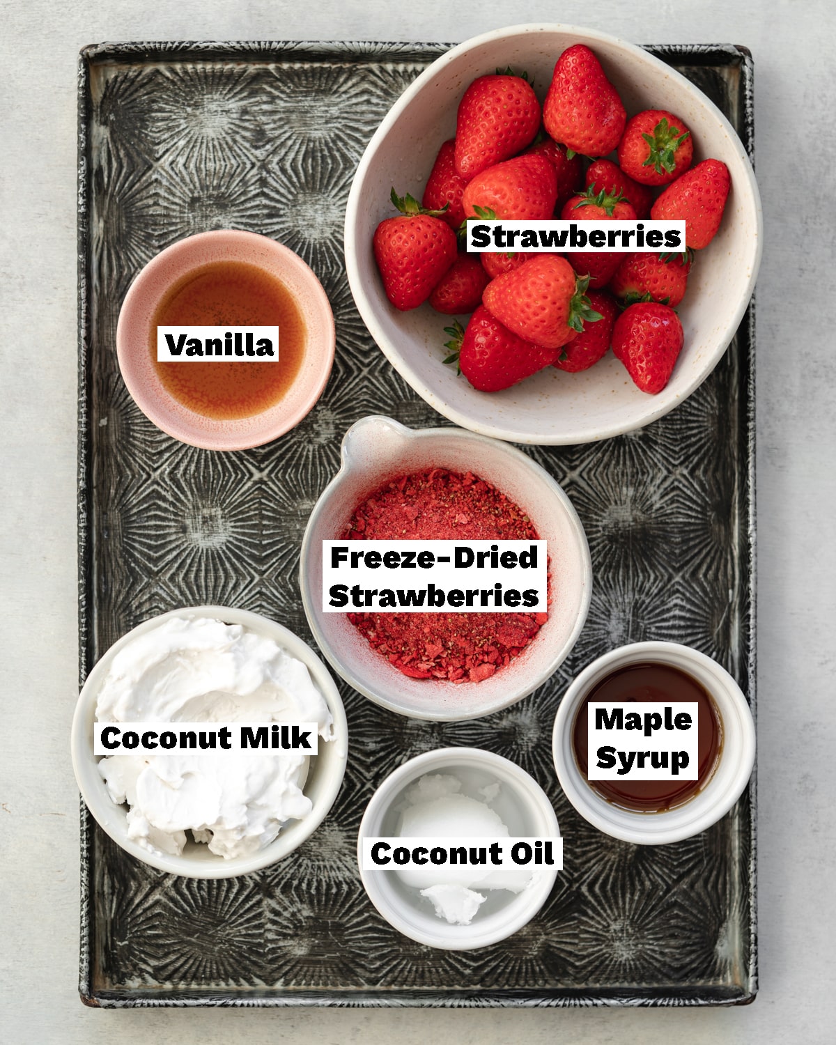 ingredients to make strawberry ice cream bars measured out on a tray.
