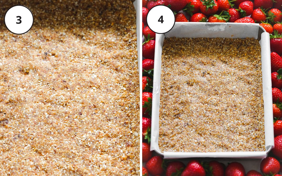 cheesecake crust pressed into a lined pan with strawberries scattered around it.