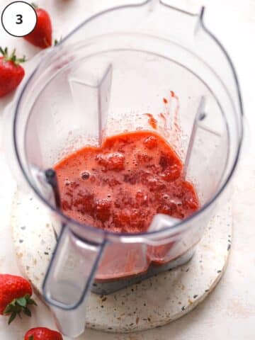 cooked strawberries in a blender jug.