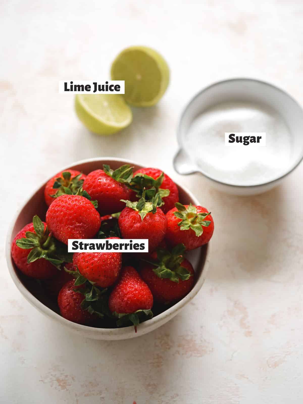 ingredients to make easy strawberry coulis measured out in bowls.