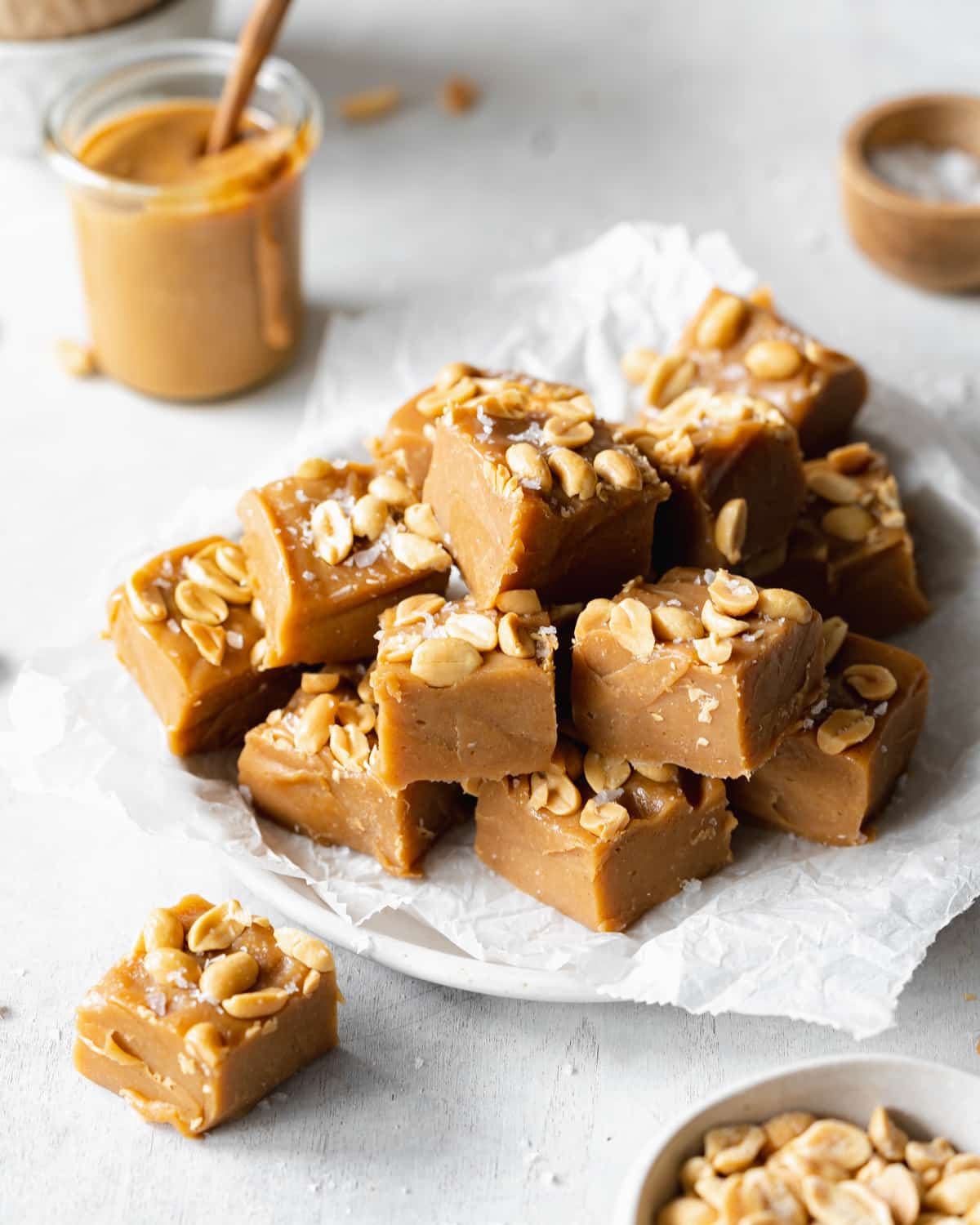 peanut butter fudge on a plate with parchment paper.