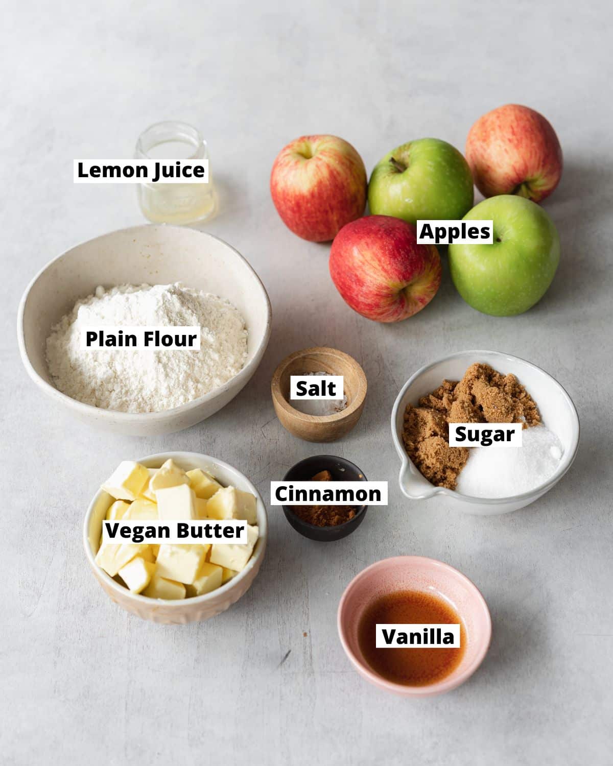 ingredients to make vegan apple crumble measured out in bowls.