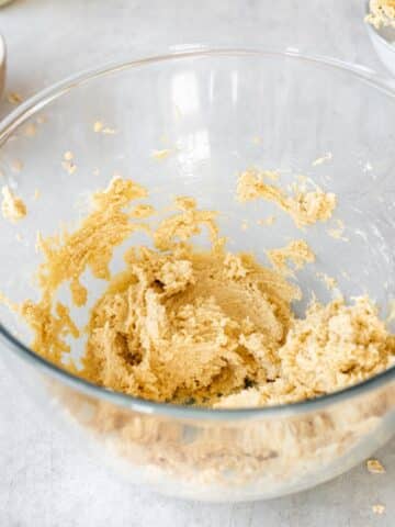 brown and granulated sugar creamed with softened vegan butter in a bowl.