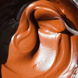 chocolate ganache in a bowl with a spoon.
